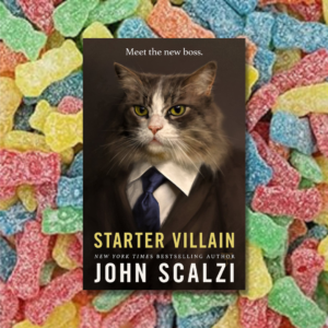 Starter villain by john scalzi in front of a rainbow array of sour patch kids