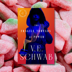 the fragile threads of power by v.e. scwab in front of an array of sour patch kids watermelons