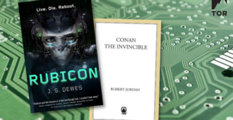 rubicon by j. s. dewes by conan the invincible by robert jordan in front of a green silicon wafer etched computer chip close up