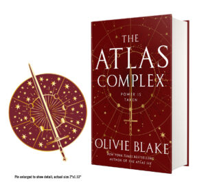 left: enamel pin with sword and starscape design on the atlas complex cover right: the atlas complex by olivie blake text: pin enlarged to show detail; actual size 2"x1.53"