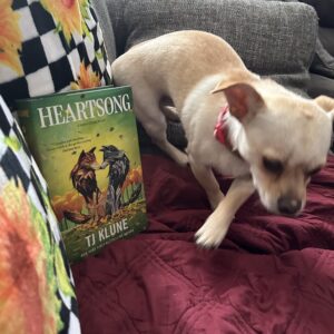 rosie the chihuahua on the move next to heatsong by tj klune