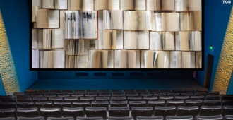 interior of a movie theater but the screen is just open pages of many books 35A